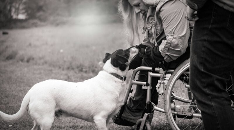 grayscale photo of woman holding dog